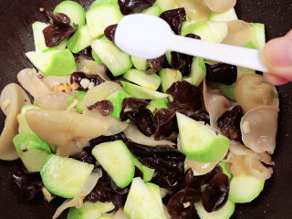 13、西葫芦炒木耳,加入一勺盐。