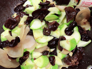 14、西葫芦炒木耳,加入少许生抽。