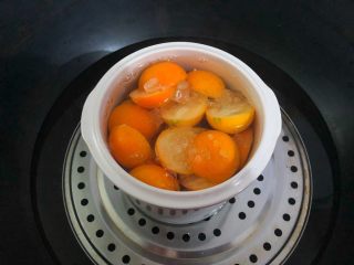 6、荸荠金桔糖水,锅里放入适量水烧开，放入蒸架，把罐子放到蒸架上，在罐子里倒入开水。