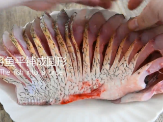 13、谁说厨神才会做，2分钟学会这道花开富贵鱼,将鱼平铺成圆形，鱼头放入圣女果点缀