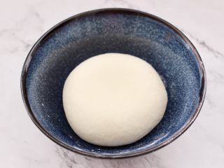 2、老面红枣花样馒头,加入白糖和温水混合均匀后,和成光滑的面团,打上保鲜膜放温暖处进行发酵。
