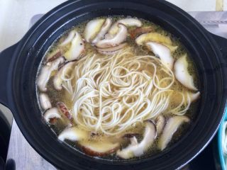 18、来一碗冬日暖食➕香菇小棠菜鸡汤面,将煮的七成熟的挂面放入，可以把香菇用筷子拨在一边