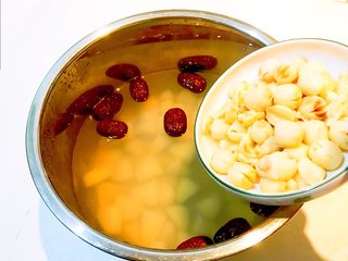 15、冰糖雪梨莲子羹,把煮好的莲子放入锅里