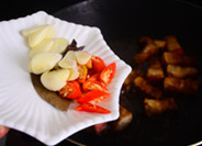 5、萝卜烧肉,放入辣椒段、蒜片、八角、香叶、桂皮炒匀。