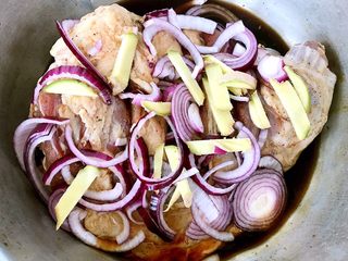 5、烤羊腿,调味料均匀的涂抹在羊腿上将切好的圆葱和姜摆入羊腿中盖上保鲜膜放入冰箱冷藏25小时煨制入味