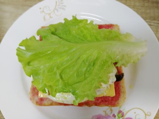 11、鸡蛋芝士全麦三明治,铺上一片生菜。