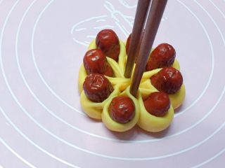 14、富贵花开枣花馍,如图：再用筷子从中间部位夹紧。
