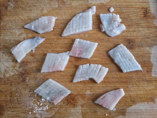 3、海鲜疙瘩汤,然后将打好花刀的鱿鱼板切成大小合适的块。