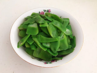 10、爆炒豆角,把焯好的豆角捞出来沥干水份