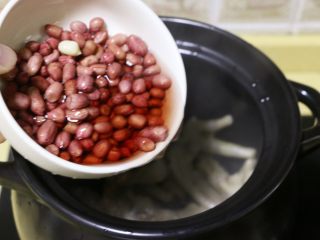 7、红枣花生凤爪汤,将泡好的花生连同浸泡花生的水一起倒入锅中