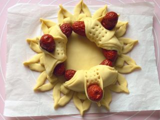 15、吉祥枣花馍,如图：依法制作3个相同大小的花瓣，然后摆放在之前做好的枣花馍底盘上。