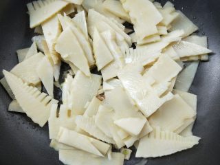 12、春笋炒腊肠,倒入沥干水的笋片，翻炒。