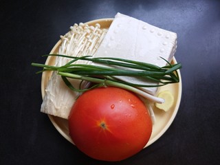 2、茄汁金针菇炖豆腐,准备食材洗净,豆腐是两元钱的,番茄是一个大的。
