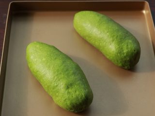 18、全麦抹茶果干软欧,收口朝下摆入烤盘，放在烤箱发酵，温度约35度，放热水确保湿度