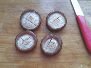 5、香菇素“鲍鱼”,香菇捞起，用手轻轻挤压多余水份，然后用小刀打上十字花刀；