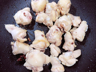 9、小鸡炖蘑菇粉条,放入鸡翅根翻炒均匀。