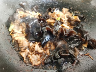 14、黄瓜木耳炒肉,加入木耳和辣椒翻炒。