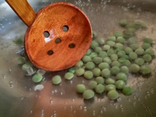 3、耳光炒饭,烧一锅热水，放入豌豆，汆煮2分钟