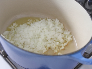 6、辣味香脆比萨,在中火大，倒入橄榄油。加入洋葱和甜椒，搅拌5分钟直到变软。加入大蒜，煮1分钟。