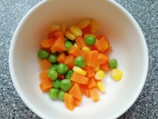 6、火腿肠披萨, 胡萝卜洗干净切成小丁，和青豆玉米粒一起焯熟。