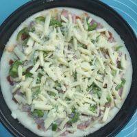 13、火腿培根披萨,最后撒上剩余的马苏里拉奶酪和芝士粉，烤箱提前预热190度，放入烤箱中层上下火16分钟