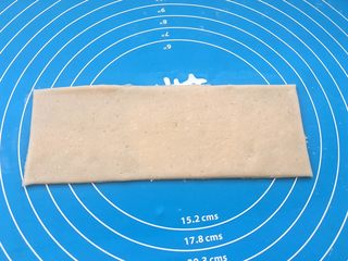 10、玫瑰豆沙一口酥,面团分成两份,用擀面杖擀成长方形(不整齐部分可以用刀切掉)。