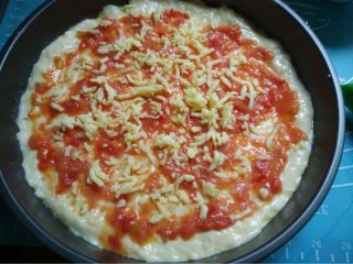 3、虾鲜拼QQ肠披萨,如图放入番茄酱涂抹均匀再洒点马苏里拉芝士