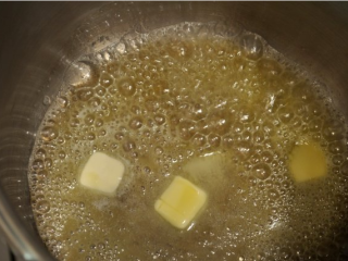 2、芝士南瓜汤,锅放入黄油，中火加热熔化。加入面粉和大蒜，边煮边搅拌，约2分钟。加入苹果酒、南瓜泥、芥末、辣酱粉，1 / 2茶匙盐和南瓜派香料，边煮边搅拌约