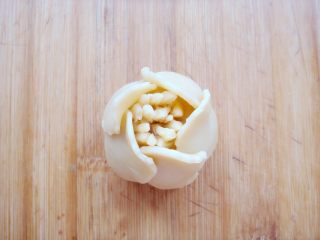 8、#甜味#花好月圆创意月饼,花瓣边缘向外稍微按压，同样方法粘贴上第二层花瓣。