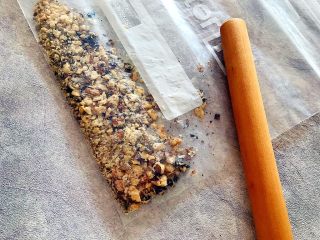 3、酥到掉渣~黑芝麻核桃可可酥酥酥,熟核桃仁放进厚一点的保鲜袋,用擀面杖敲碎