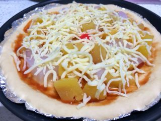 5、果缤纷披萨,铺好水果后，在上面撒上安拉刨丝马苏里拉芝士奶酪