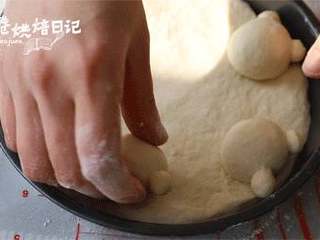 9、当笨笨的小熊成为披萨的元素，别说是宝宝了，妈妈都被可爱到了,将小熊的脸，耳朵面团搓成圆形，装饰在饼底上。