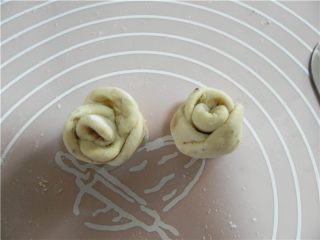 6、香蕉苹果披萨,从下端由上卷起。用刀从中间切开，做好2朵玫瑰花。预热烤箱200度。