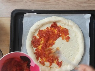 16、薯泥培根披萨,卷好后，面饼用叉子，叉小眼，然后铺上一层披萨酱