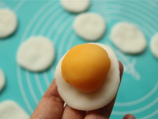 14、fluff草莓味棉花糖奶黄冰皮月饼,取一个冰皮，按扁，放入一个奶黄馅。