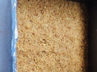 3、抹茶重芝士,将搅拌好的消化饼随，放到慕斯圈中，用勺子将消化饼压实。放入冰箱冷藏一个小时。