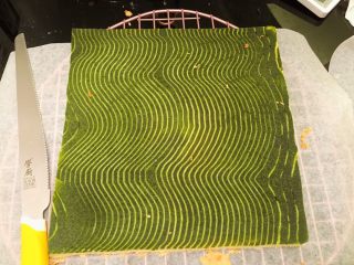 13、波浪抹茶蛋糕卷,出炉轻震几下后倒扣放至微热，面包刀切除不规则边缘