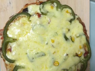 5、培根披萨,烤完25分钟后拿出再铺上一层奶酪，烤5分钟即可。