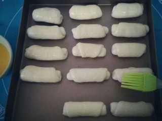 10、香甜小面包#面团的发酵之旅#,移进烤盘刷上一层蛋液。