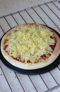 9、玄妙感觉的孜然羊肉披萨,将炒好的披萨酱铺入饼底，上边码放一层山药片，再铺一层马苏里拉奶酪。