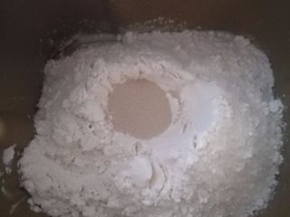 2、鲜虾火腿披萨,2.除黄油以外，将饼皮材料按下层液体，中层粉体，上层酵母的顺序，放入面包机中揉面。揉成光滑面团后加入软化的黄油，继续揉到扩展阶段就行。