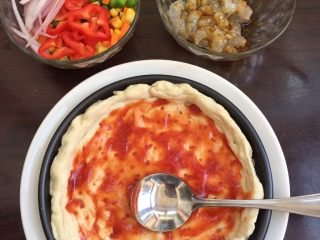 2、大虾披萨,涂上番茄沙司酱和马苏里拉奶酪，放在烤箱180度烤5分钟。