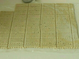 7、澎湖咸饼,用刀切成厚0.3厘米，6*3厘米的长方片，放入烤盘，戳洞。