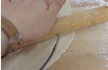 3、彩椒牛肉披萨,然后盖在pizza盘上，用擀面杖擀掉多余部分