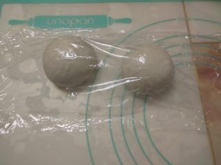 14、黑椒鸡肉披萨,按揉面团排气后，分割成两份，揉圆后加盖保鲜膜醒15分钟。