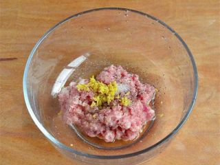 4、黄金肉饼,肉馅里调入料酒、胡椒粉、适量盐和汤匙花生油,再将姜剁末放进去,朝一个方向,打上筋,腌制10分钟以上;