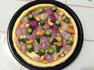 11、培根松茸披萨,再铺上洋葱、秋葵和腰果。