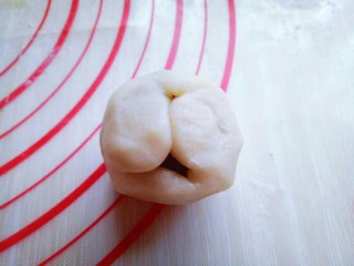 15、豆沙蛋黄月饼,用虎口手法小心将皮往上推。整理好收口并搓圆。
