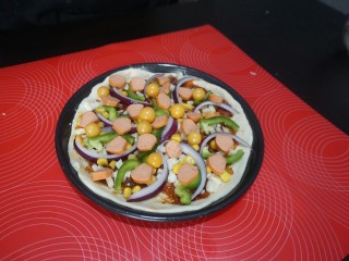 16、独家秘制香肠披萨,依次摆放好，火腿肠和小金桔，（家没有小番茄，我放的小金桔）