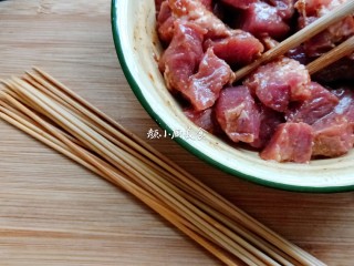 5、烤肉串,竹签用开水浸泡洗净,把腌制好的酥肉力串起来。